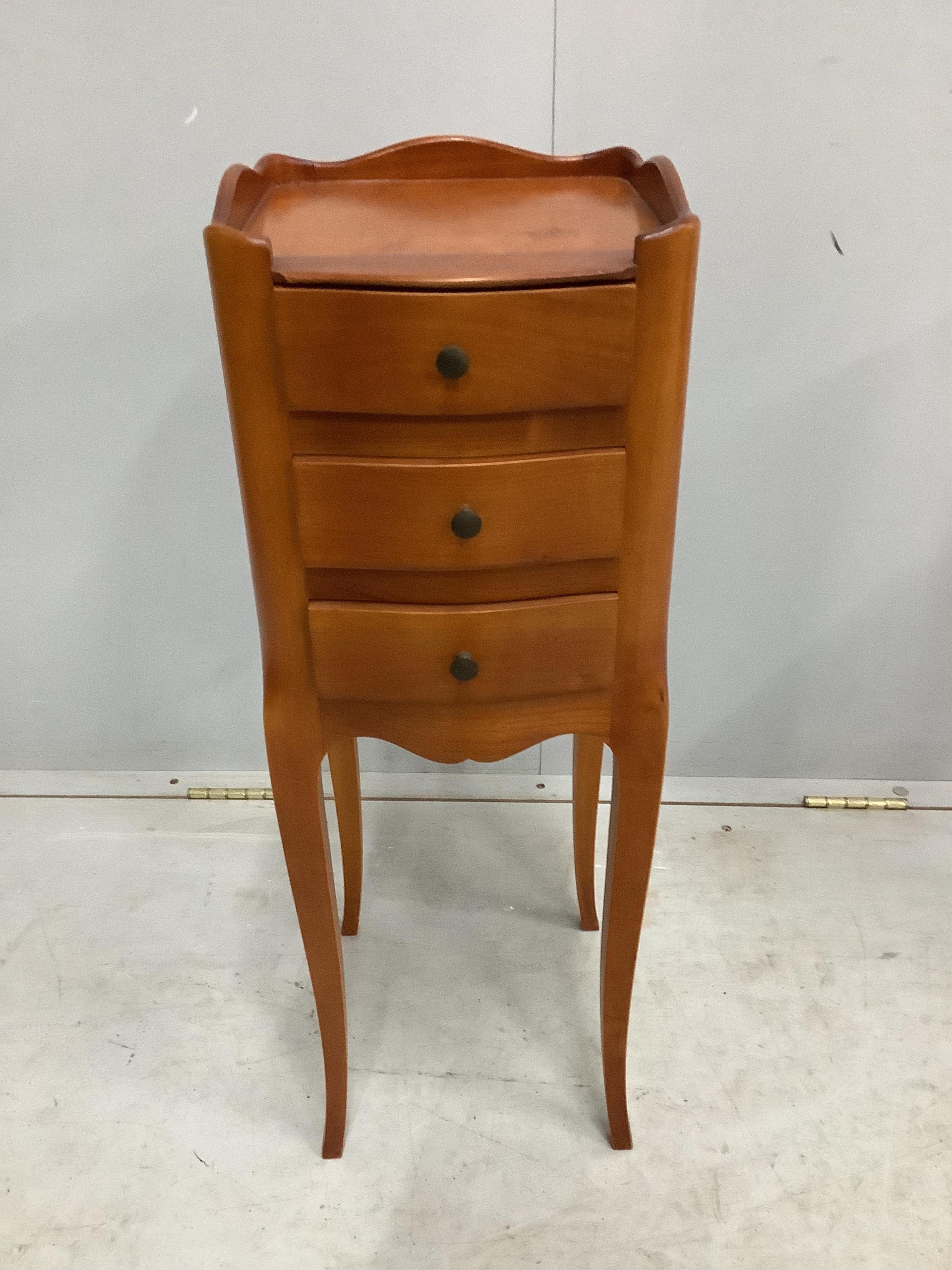 A pair of French cherry three drawer bedside chests, width 24cm, depth 26cm, height 70cm. Condition - fair to good